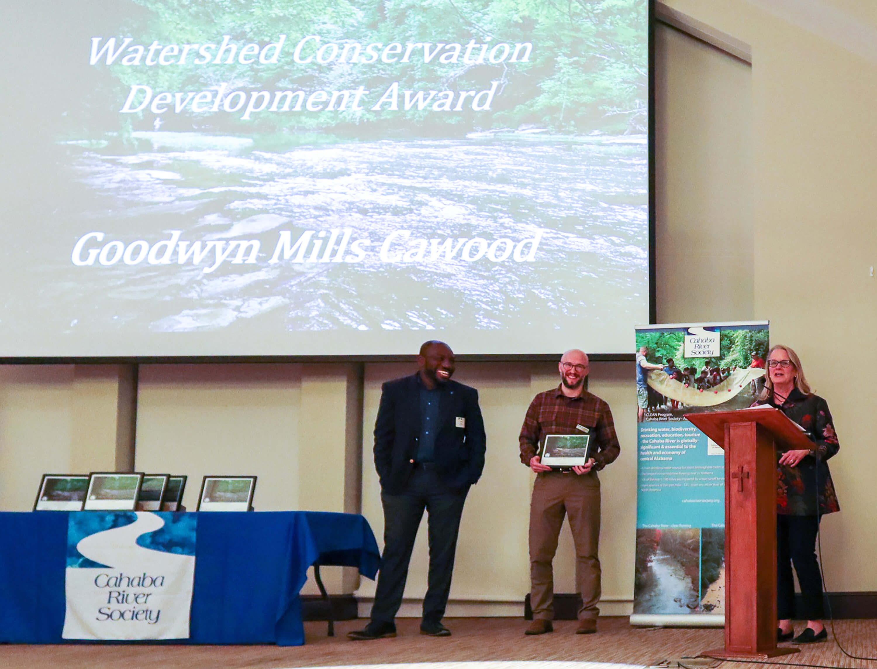 GMC Landscape Architect Jane Ross accepting the award, with CRS Board Member Bolaji Kukoyi of Dynamic Civil Solutions (left) and River Sustainability Director Ben Wegleitner (center).