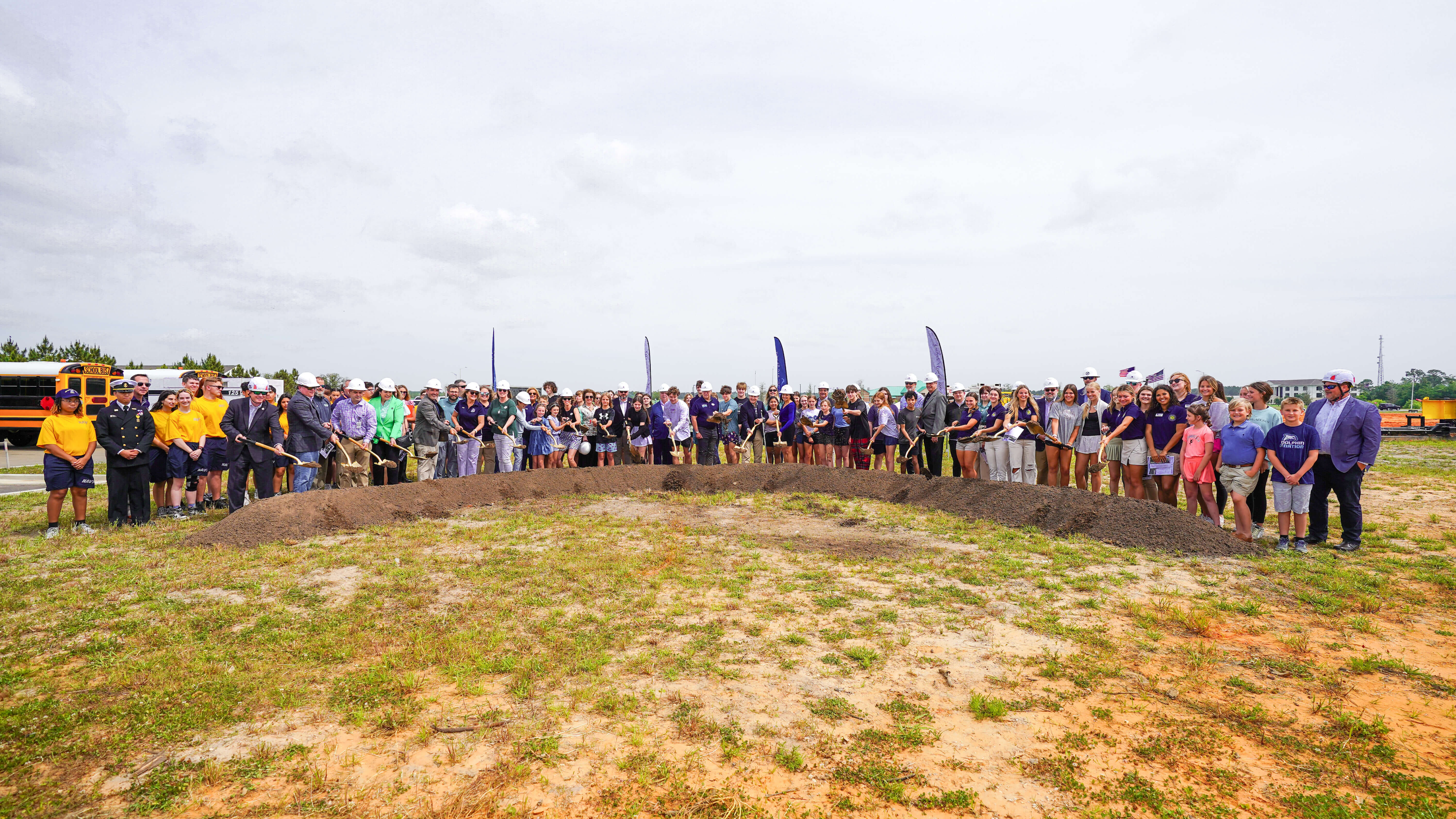 City officials, school officials, design team members and future students break ground at the new Gulf Shores High School. 