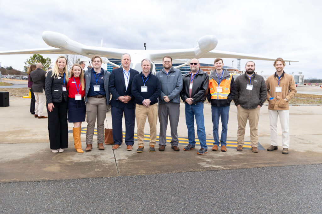 project team in front of electric aircraft charger